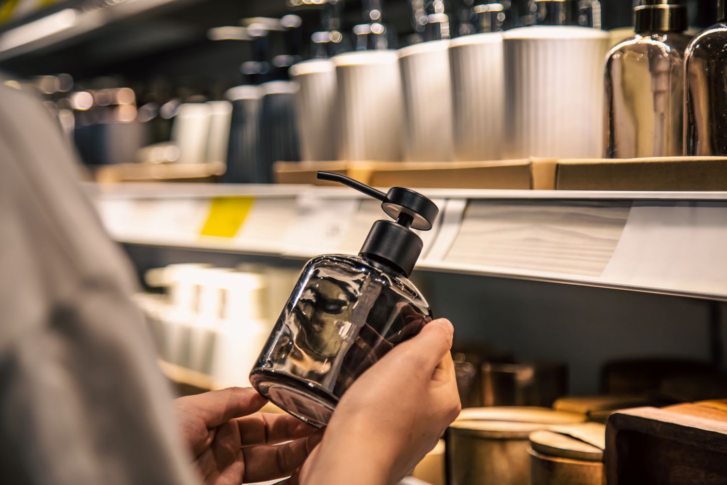 woman holding hotel soap dispenser